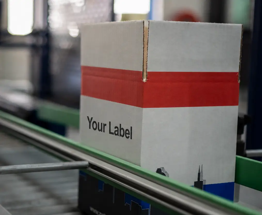 Boxed private label products on a conveyor
